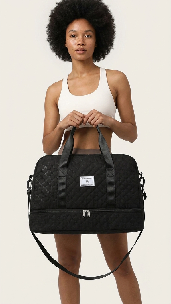 A woman holding a quilted overnight duffel in black