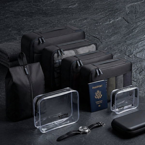 Travel organisers and clear toiletry cases on a dark surface