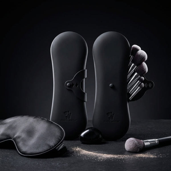 The makeup brush case shown with brushes and a sleep mask