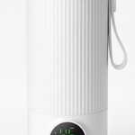 A white cylindrical electric kettle with a ribbed body, a silver metal rim, a carrying loop, and a digital display showing 45 degrees Celsius on a clean white background.