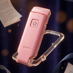 A pink portable electronic device with a clear carabiner clip, floating against a dark blue background with scattered paper sheets and ribbon decorations.