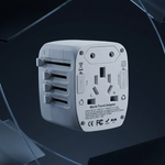 A white universal travel adapter floating against a dark, reflective background with abstract glass-like shapes.